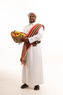 Omani Man in Traditional Dress with Fruit Basket