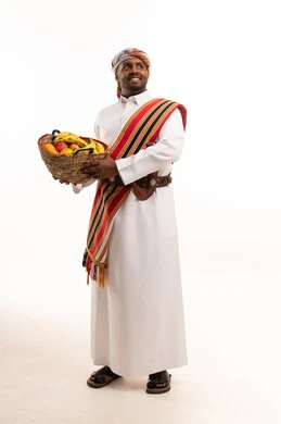 Omani Man in Traditional Dress with Fruit Basket