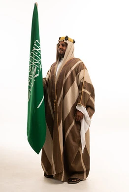 Saudi Man Holding Saudi Flag in Traditional Bisht