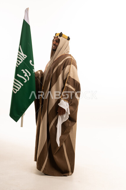 Saudi Man in Traditional Dress Holding National Flag
