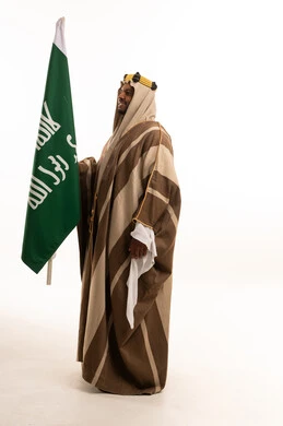 Saudi Man in Traditional Dress Holding National Flag