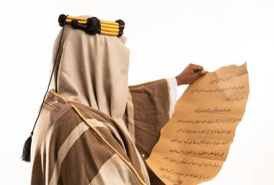 Saudi Man in Traditional Bisht Holding Ancient Scroll
