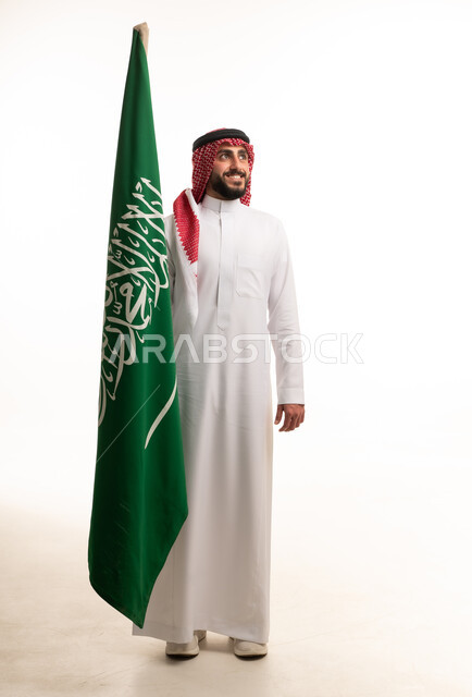 Saudi Man in Traditional Thobe with National Flag