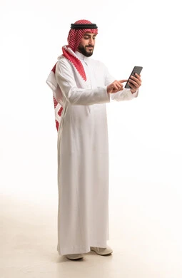 Saudi Man in Traditional Thobe Using Digital Tablet