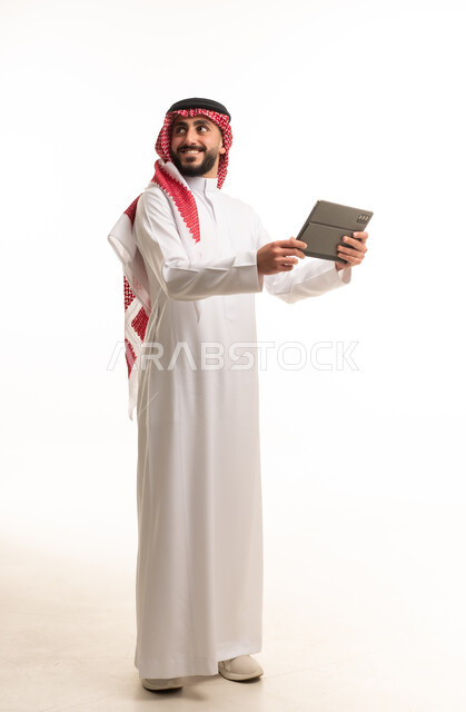 Saudi Man in Traditional Thobe Holding Tablet