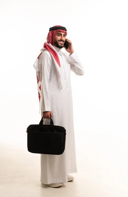 Saudi Businessman with Laptop Bag Talking on Phone