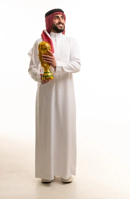 Saudi Man in Traditional Thobe Holding World Cup Trophy