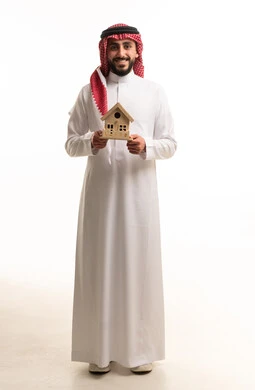 Saudi Man Holding Wooden House Model on White Background