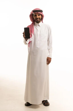 Saudi Man in Traditional Thobe Holding Smartphone Studio