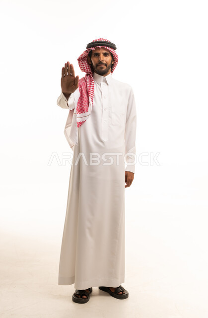 Saudi Man in Traditional Thobe Making Stop Gesture