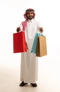 Saudi Man Holding Shopping Bags in Studio