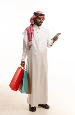 Saudi Man with Shopping Bags and Smartphone on White