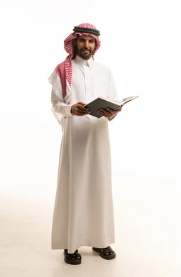 Saudi Man in Thobe Holding Book on White Background