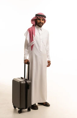Saudi Man in Traditional Thobe with Suitcase