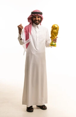Saudi Man Holding World Cup Trophy in Traditional Dress