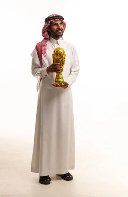 Saudi Man Holding Gold Football Trophy in Studio