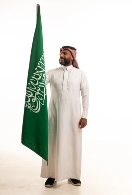 Saudi Man Holding Saudi Arabia Flag on White Background
