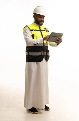 Saudi Engineer in Safety Vest Using Tablet