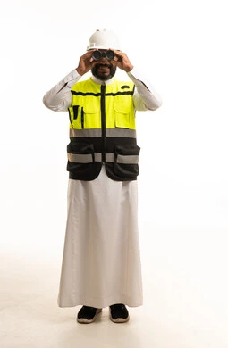 Saudi Engineer in Safety Vest Looking Through Binoculars