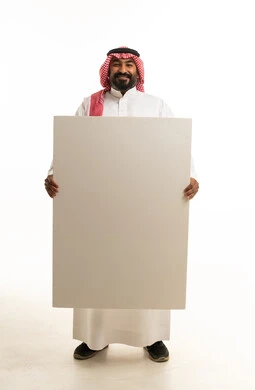 رجل عربي يحمل لوحة بيضاء فارغة في الاستوديو