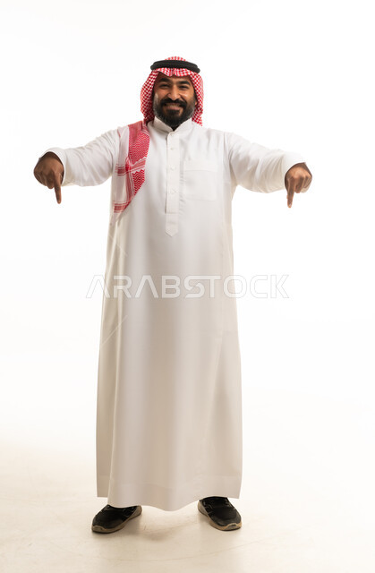 Saudi Man in Traditional Dress Pointing Downward Studio