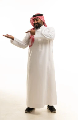 Saudi Man in Traditional Thobe Pointing at Palm