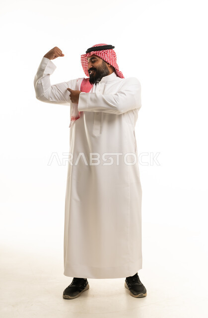 Saudi Man in Traditional Thobe Flexing Muscle Studio Shot