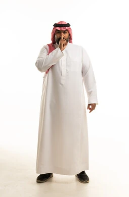 Saudi Man in Traditional Dress Making Silence Gesture
