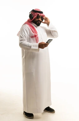 Saudi Man with Headphones and Smartphone in Studio