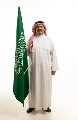 Saudi Man Holding National Flag on White Background
