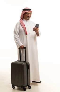 Saudi Man with Suitcase and Smartphone on White Background