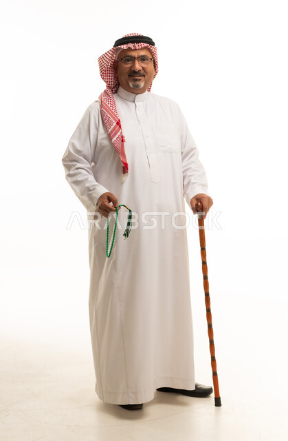 Saudi Man in Traditional Thobe Holding Walking Stick