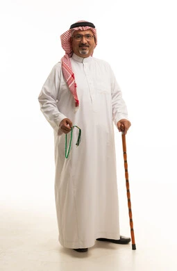 Saudi Man in Traditional Thobe Holding Walking Stick