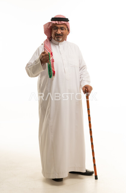 Saudi Man in Traditional Thobe with Prayer Beads and Cane