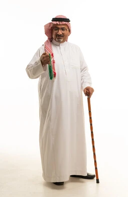 Saudi Man in Traditional Thobe with Prayer Beads and Cane