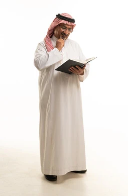 Middle Aged Saudi Man Reading Book on White Background