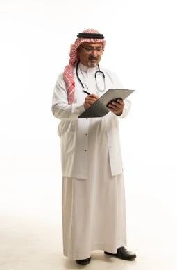Saudi Doctor Writing on Clipboard Against White Background