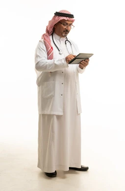 Saudi Doctor Using Tablet on White Background