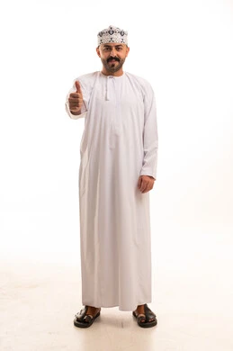 رجل عُماني بالزي التقليدي يشير بالإبهام