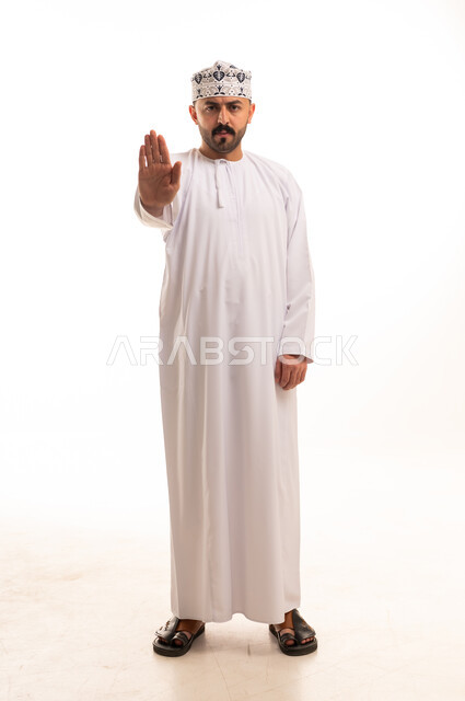 Omani Man in Traditional Dress Making Stop Gesture