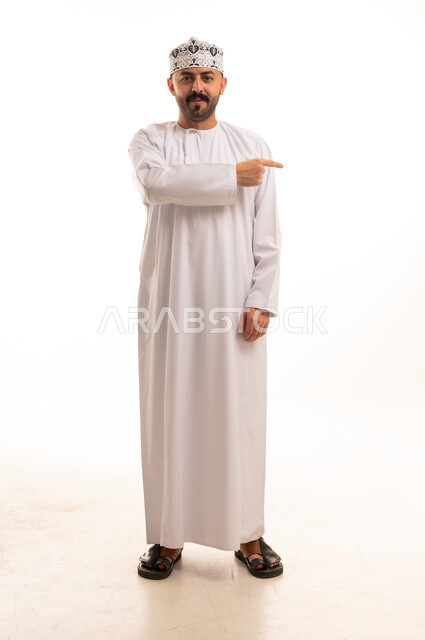 Omani Man in Traditional Dress Pointing to the Side