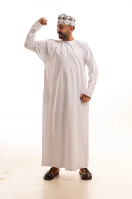 Omani Man in Traditional Dishdasha Flexing Muscles