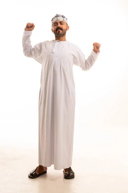 Omani Man Stretching in Traditional Dishdasha and Kumma