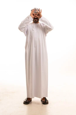Omani Man in Traditional Dishdasha Making Vision Gesture