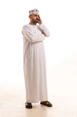 رجل عماني بالدشداشة التقليدية على خلفية بيضاء