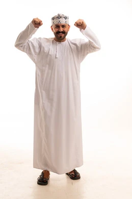 Omani Man in Traditional Dress Flexing Muscles