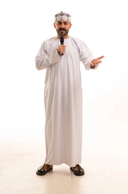 Omani Man Speaking with Microphone in Traditional Dress