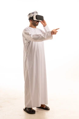 Omani Man Wearing VR Headset in White Dishdasha