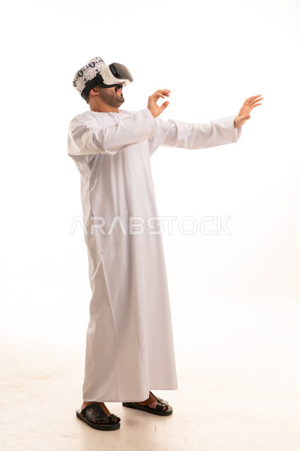 Omani Man in Traditional Dishdasha Using VR Headset