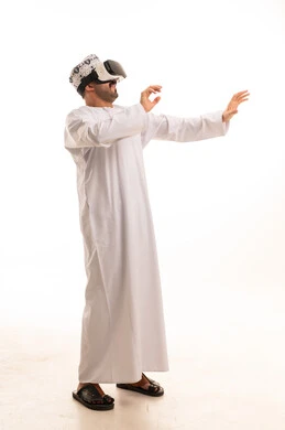 Omani Man in Traditional Dishdasha Using VR Headset